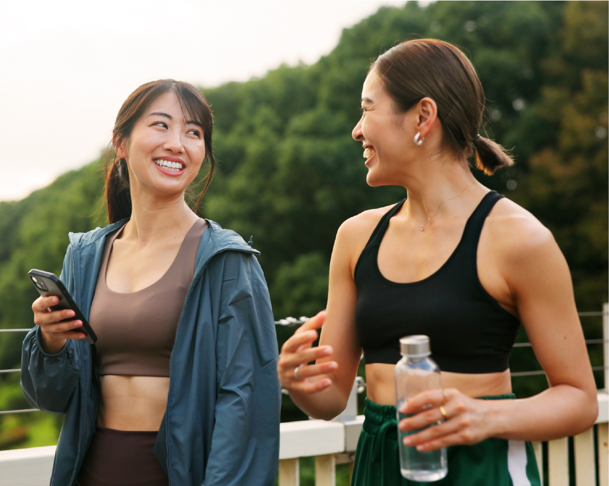 Two women talking while taking a walk outside.